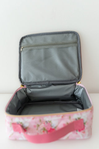 Floral-patterned suitcase with open lid on a white background