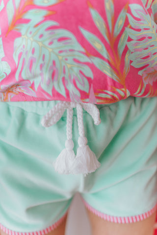 Close-up of a tropical-themed outfit with pink and green colors.