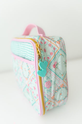 Small pouch with floral pattern and heart-shaped zipper pull on a white background