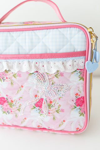 Pink floral bag with butterfly design on a white background