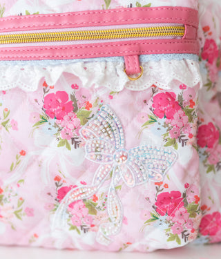 Floral-patterned pouch with a decorative bow and pink zipper.