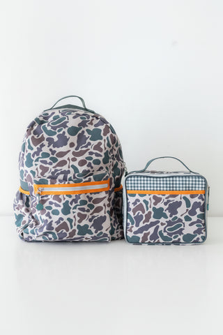 Camo backpacks and a lunch bag on a white background