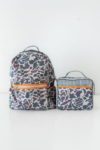 Two patterned backpacks and a lunch bag on a white background