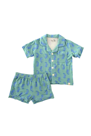 Children's green pajama set with blue patterns on a white background