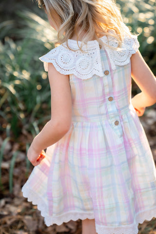 Pastel plaid dress with lace collar worn by a child outdoors