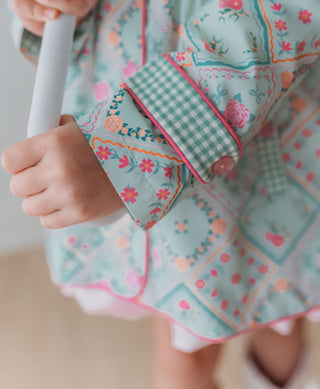 Sleeve of a floral patchwork rain jacket
