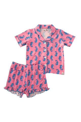 Pink children's pajama set with blue seahorse pattern on a white background