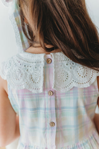 Pastel plaid dress with lace collar and buttons, worn by a person.