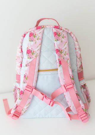 Floral-patterned backpack with pink straps on a white background